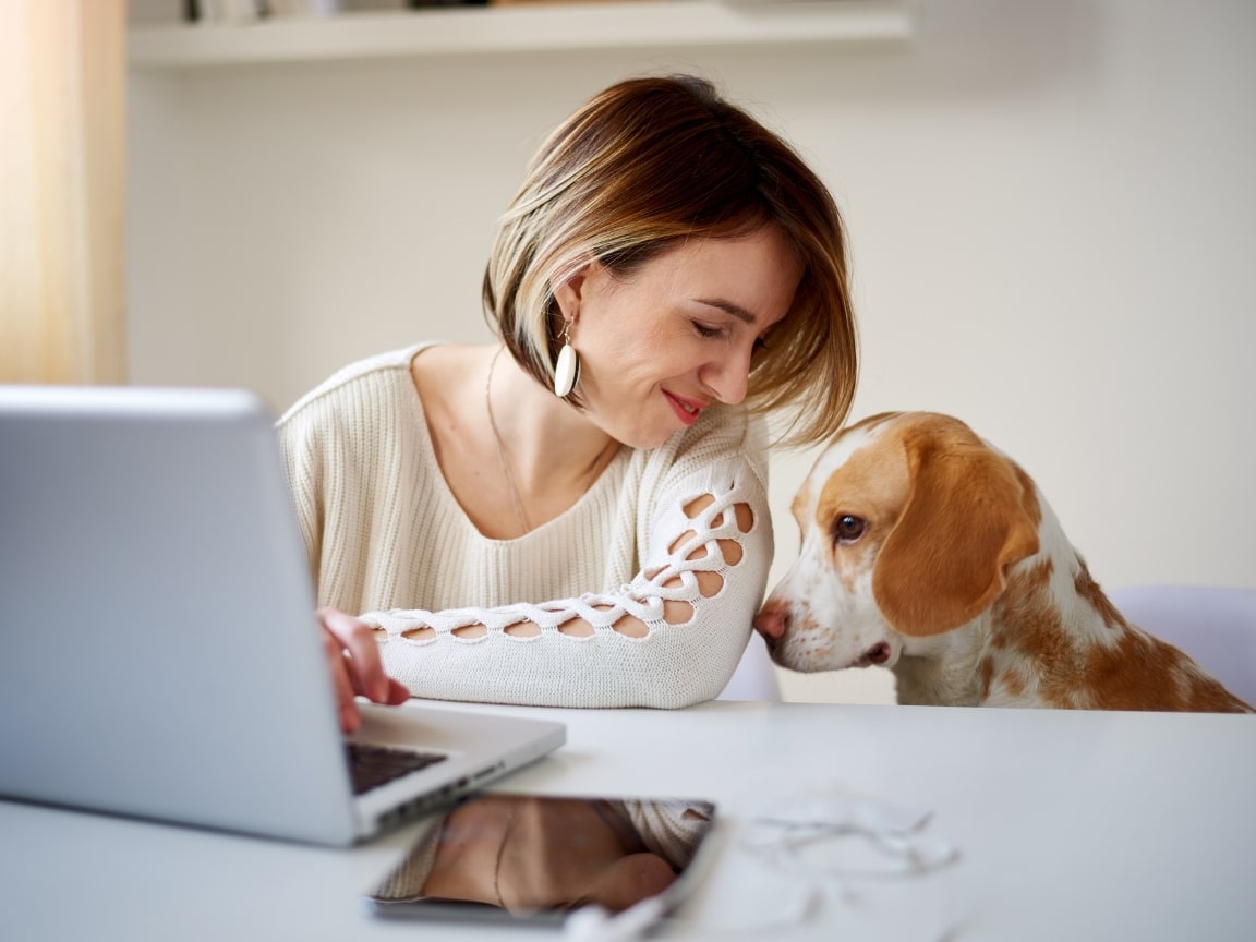 Woman starting a pet blog with her dog